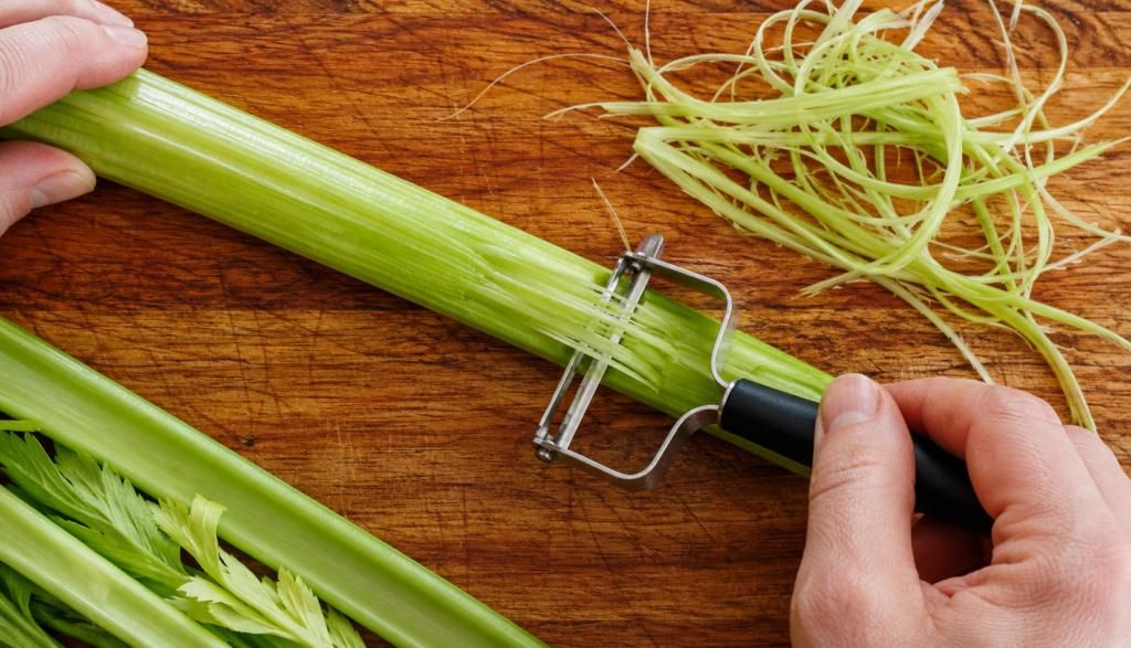 ChatGPT Image Jun 22, 2026, 05_10_05 PM Celery stalk being peeled to remove stringy fibers on cutting board